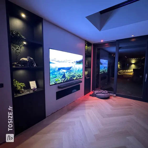 Black cupboard wall with open compartments and doors