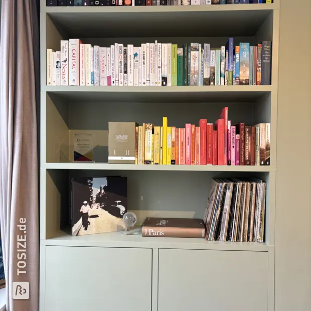 Green bookcase with open shelves and doors
