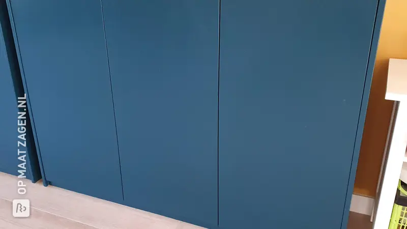 Stylish blue plywood game cabinet, by Rick