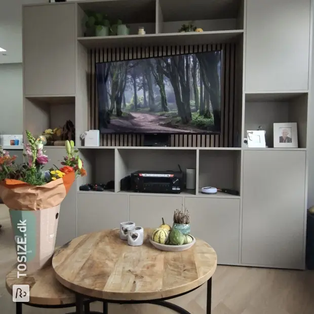 Beige cupboard wall with open compartments and doors