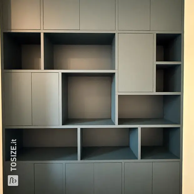 Dark (wood) cupboard wall with doors and open compartments
