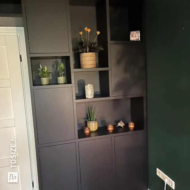 Black cupboard wall with doors and open compartments