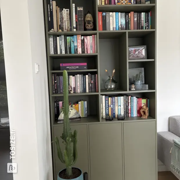 Green shelving unit with open compartments and doors