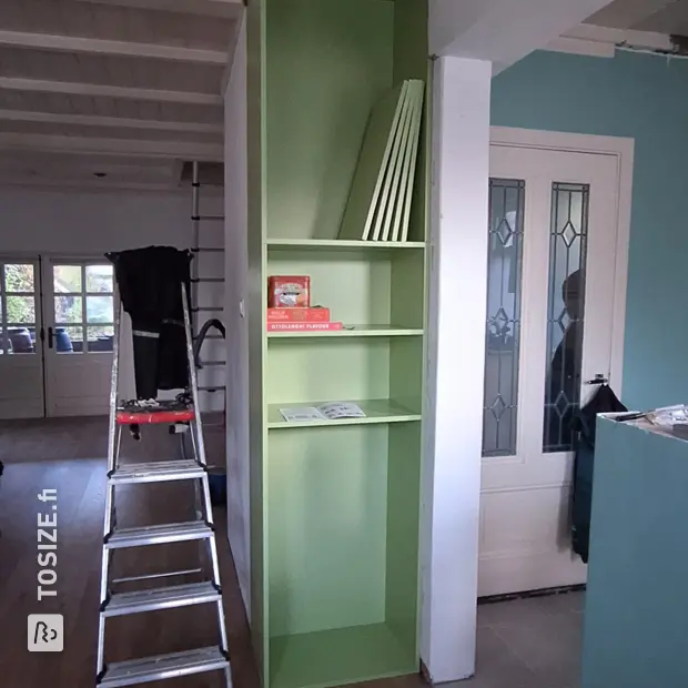Green cabinet with doors and open compartments