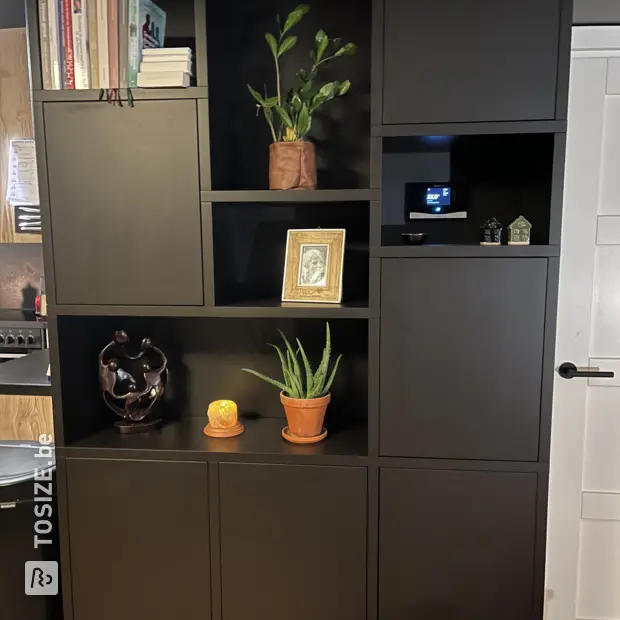 Black bookcase with open shelves and doors