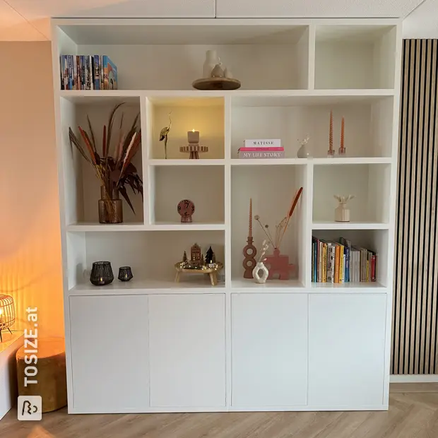 White shelving unit with open compartments and doors
