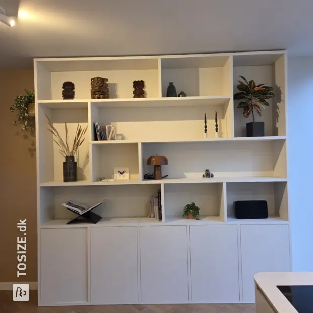 White cupboard wall with open compartments and doors