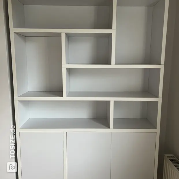 White cupboard wall with doors and open compartments