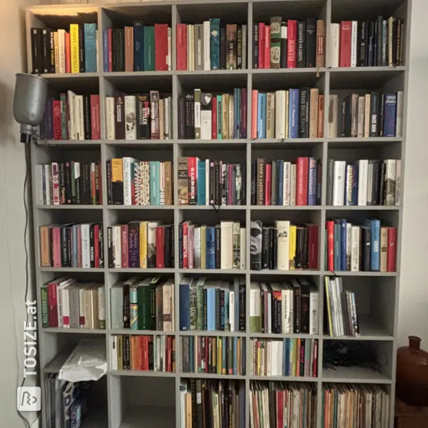Gray bookcase with open compartments and shelves