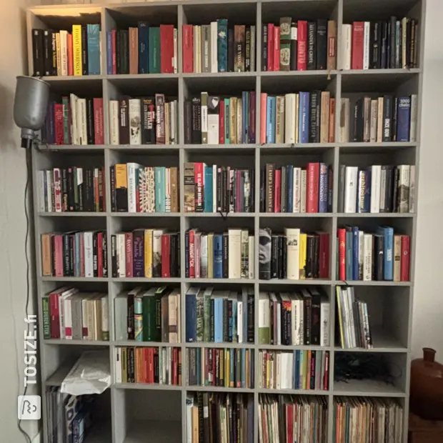 Gray bookcase with open compartments and shelves
