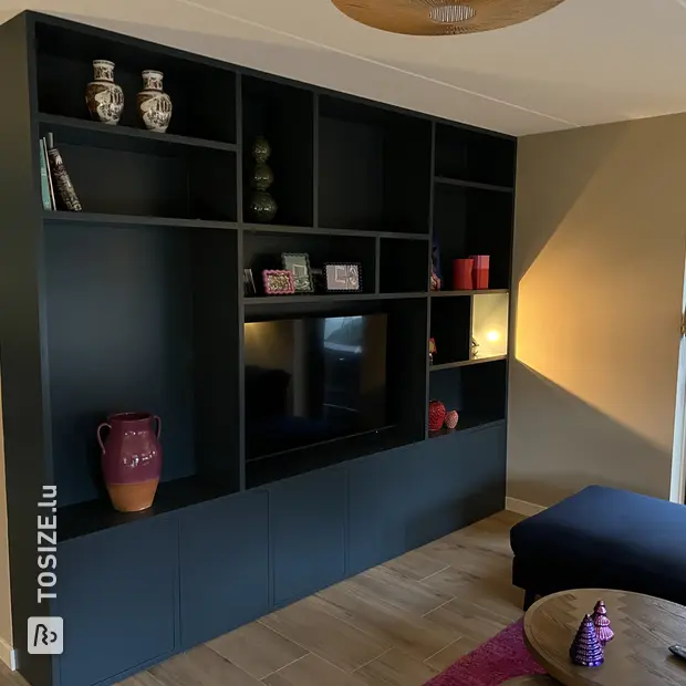 Black cupboard wall with open compartments and doors