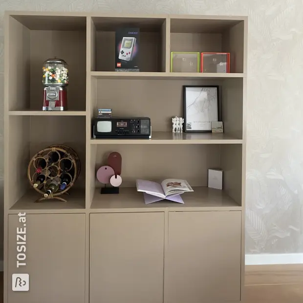 Cream bookcase with open compartments and doors