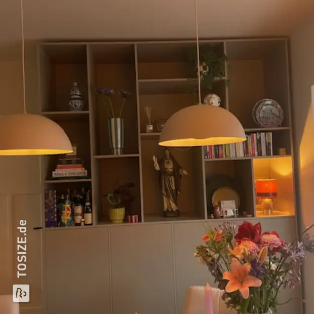 Beige cupboard wall with open compartments and doors