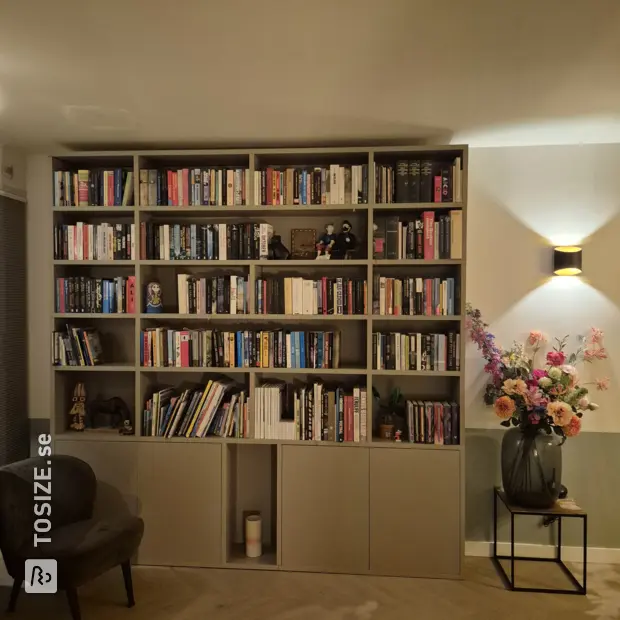 Gray bookcase with doors and open compartments
