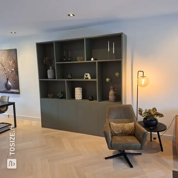 Green cabinet with doors and open compartments