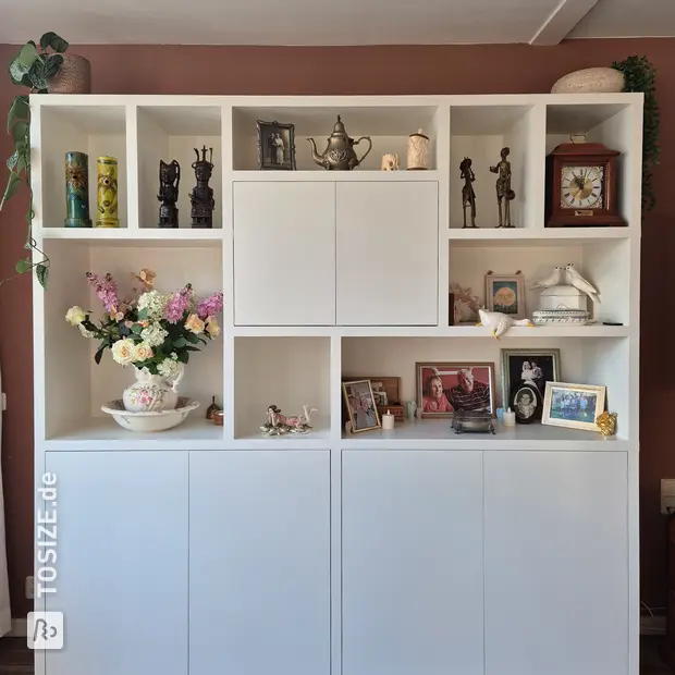 White cupboard wall with open compartments and doors