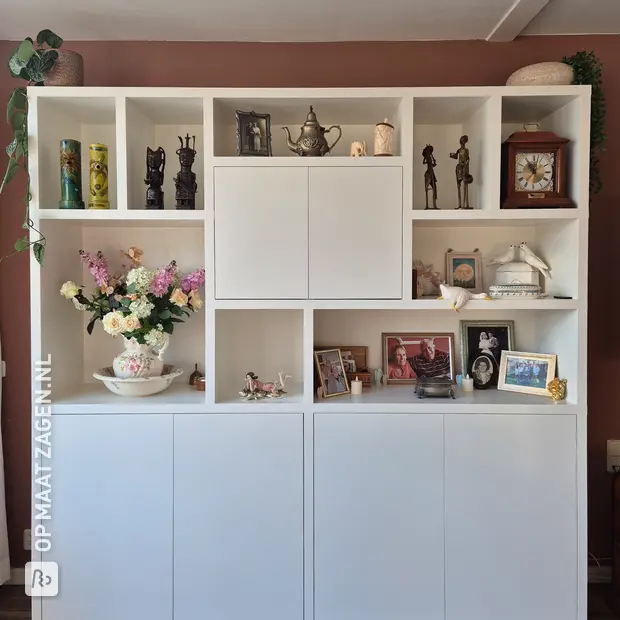 White cupboard wall with open compartments and doors