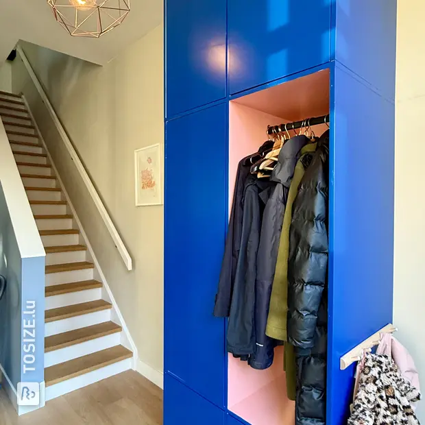 Blue shoe cabinet with doors and open compartments