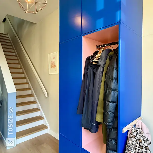 Blue shoe cabinet with doors and open compartments