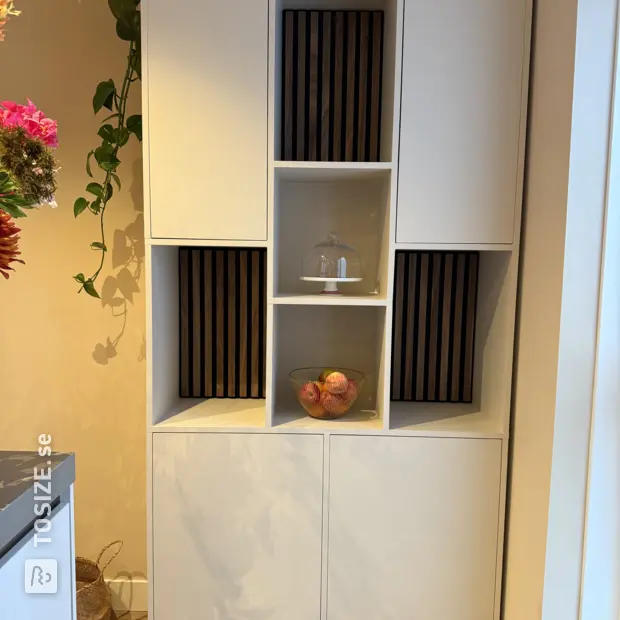 White cupboard wall with doors and open compartments