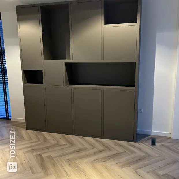 Gray cupboard wall with open compartments and doors