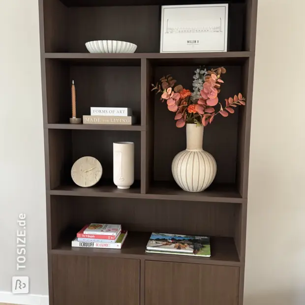 Dark wooden bookcase with open shelves and doors