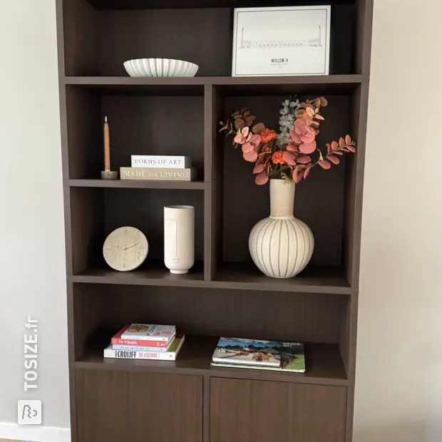 Dark wooden bookcase with open shelves and doors