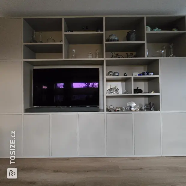 Cream cupboard wall with open compartments and doors