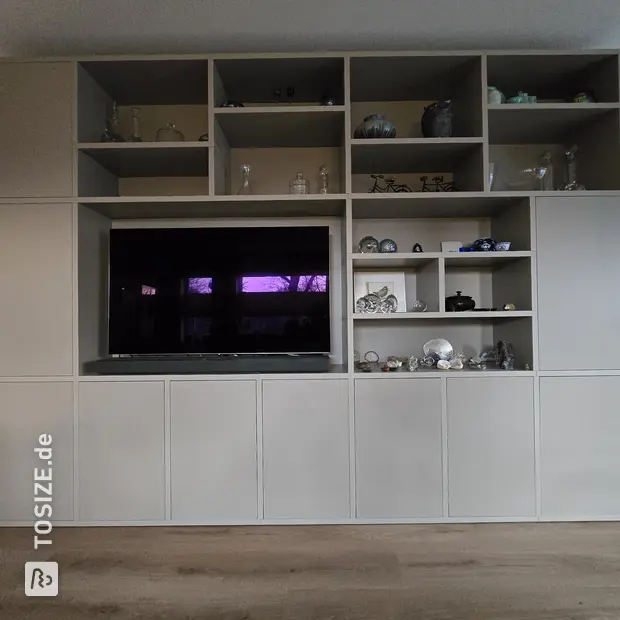 Cream cupboard wall with open compartments and doors