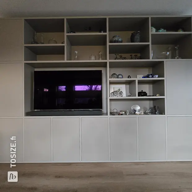 Cream cupboard wall with open compartments and doors