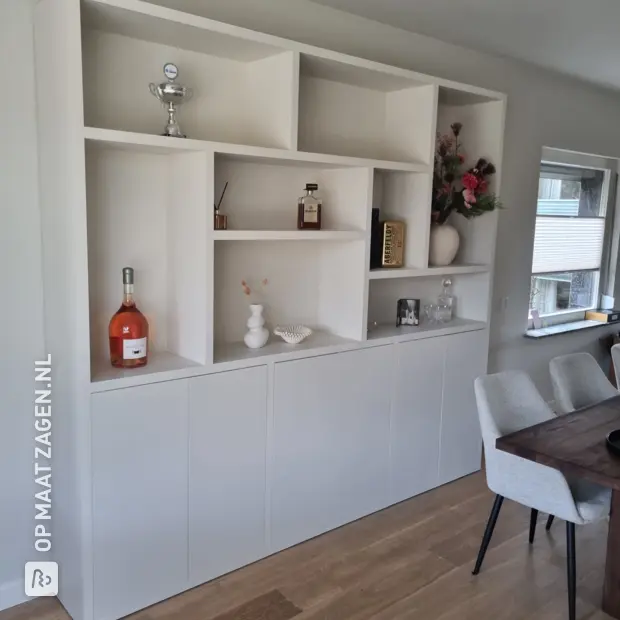 White cupboard wall with open compartments and doors