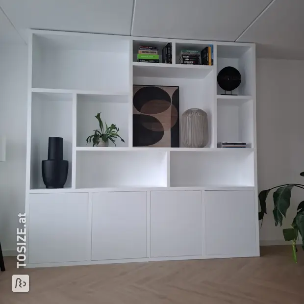 White shelving unit with open compartments and doors