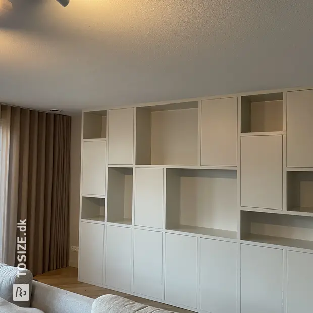 White cupboard wall with open compartments and doors