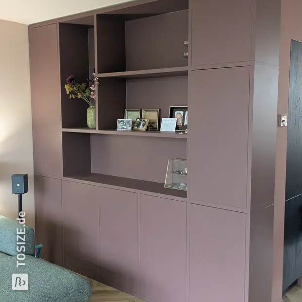 Purple cupboard wall with open shelves and doors