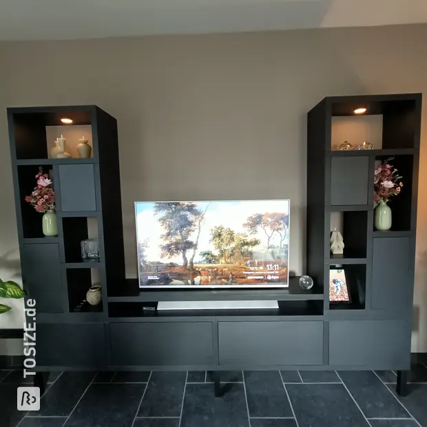 Black cupboard wall with open compartments and doors