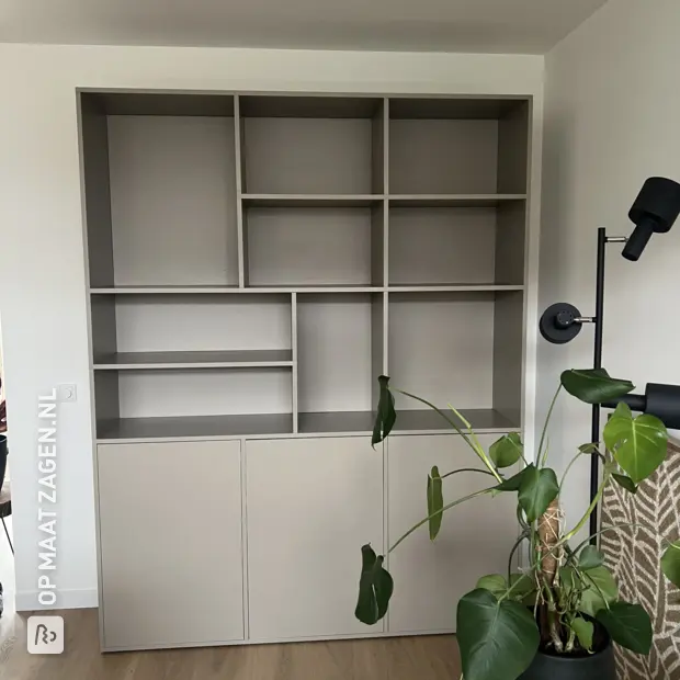 Gray cupboard wall with doors and open compartments