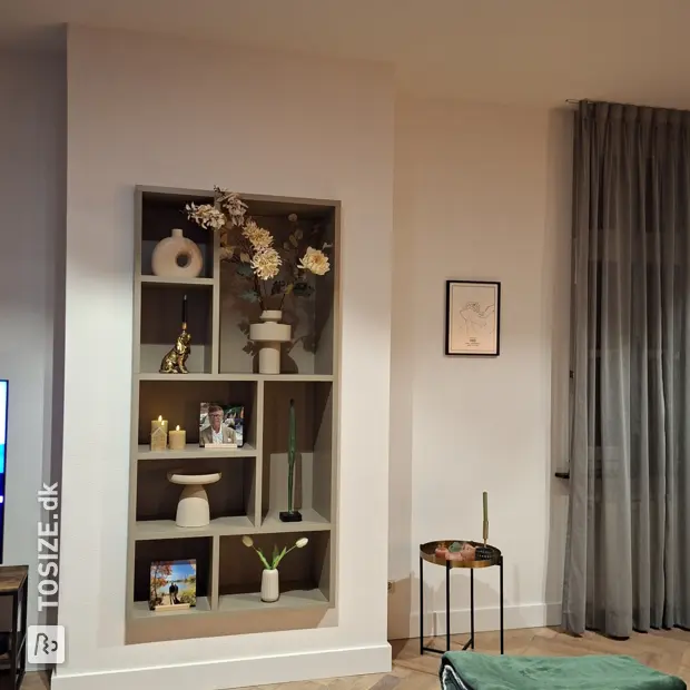 Beige display cabinet with open compartments and shelves