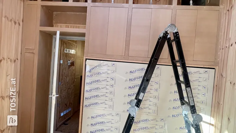 Space-saving built-in wardrobe with folding bed, by Madelon