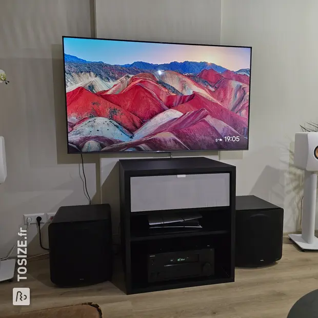 Black TV cabinet with doors and open compartments