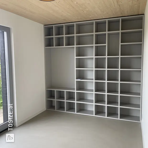Grey compartment cabinet with open compartments and shelves