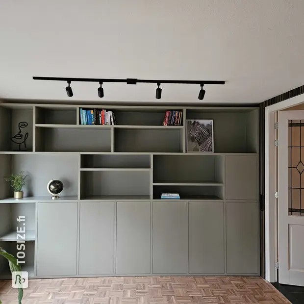Green wall unit with doors and open compartments