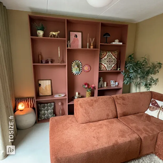 Red bookcase with open compartments and shelves