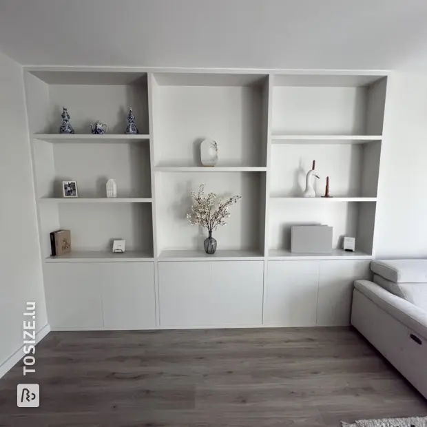White wall unit with doors and open compartments