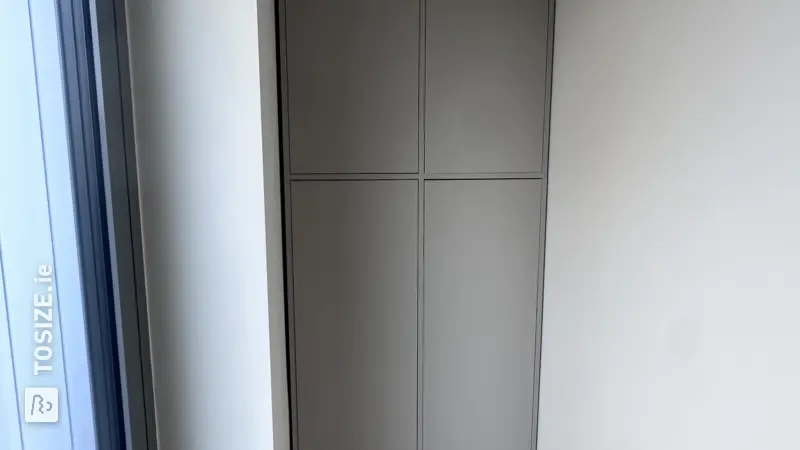 Custom-made cabinet in a hallway alcove by Frank