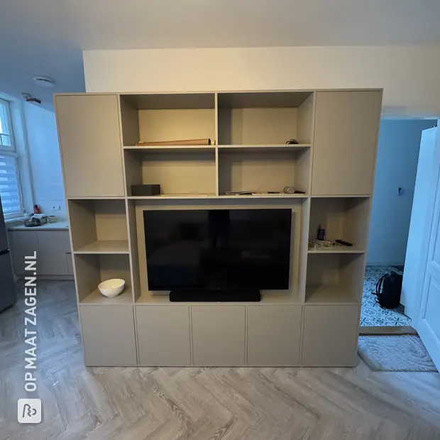 Cream wall unit with open compartments and doors