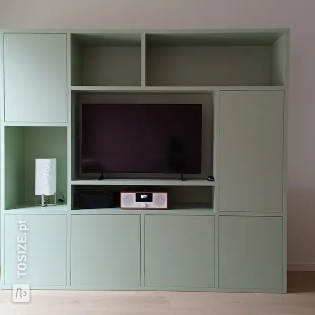 Green wall unit with open compartments and doors