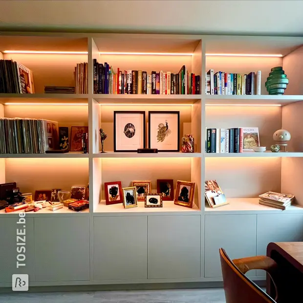 Grey bookcase with open compartments and doors
