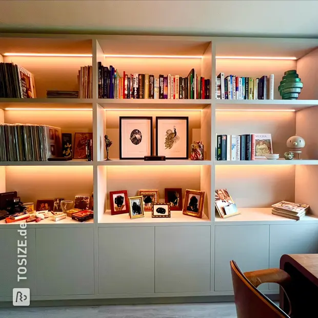 Grey bookcase with open compartments and doors