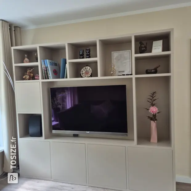 Cream wall unit with open compartments and doors