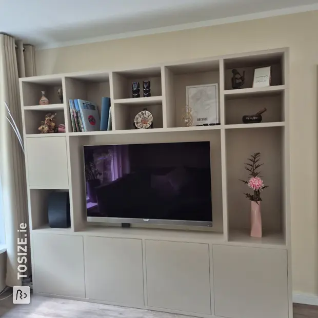 Cream wall unit with open compartments and doors